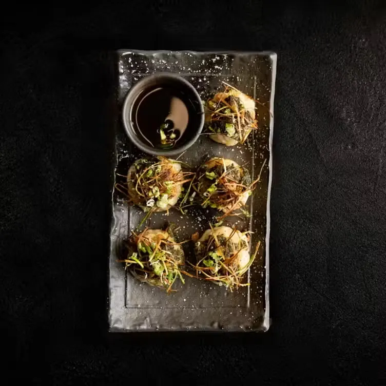 Crisped dumplings with scallion and dipping sauce